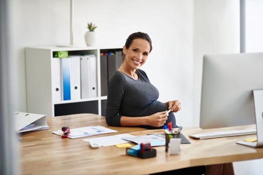 Maternity and the modern businsswoman. Portrait of a pregnant businesswoman working in an office.
