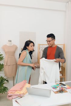 Two fashion designers working together on a desk