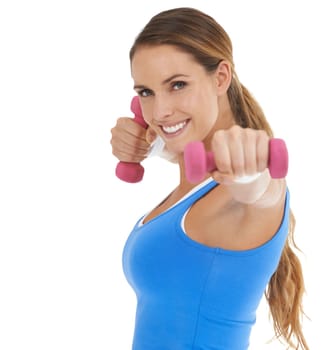 Using dumbbells to boost her workout. Fit young woman smiling while using dumbbells against a white background.