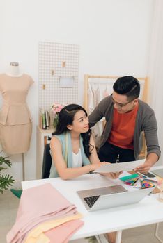 Fashion designers working on creation in workshop