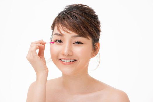 Beauty woman showing cotton swab on face - eye and skin care concept.