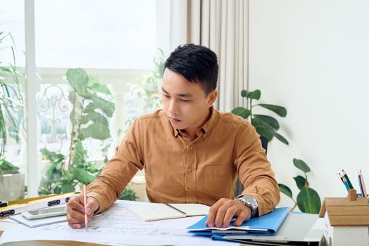 Asian Handsome male architect working in office