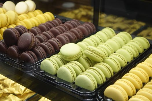 colored macaroons displaying for sale at local store