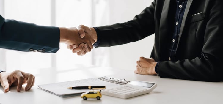 Handshake of cooperation customer and salesman after agreement, successful car loan contract buying or selling new vehicle