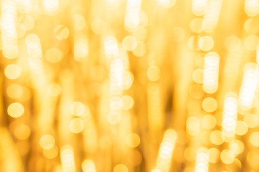 The Abstract yellow light twinkled bright background with bokeh defocused lights.