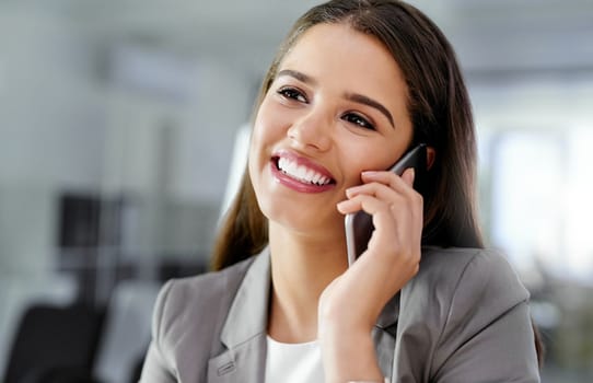 I appreciate your positive feedback...a young businesswoman talking on a cellphone in an office.