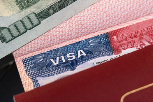 Passport with US visa and one hundred dollars as a tourist travel idea