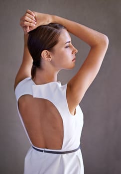 Sultry elegance of the business beauty. Profile shot of a young woman in a white dress.