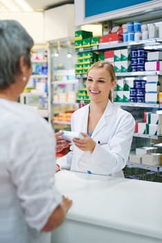 Efficient and undeniably friendly service. a young pharmacist assisting a customer.