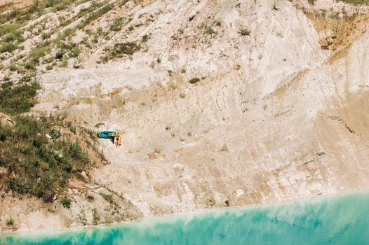 Vaukavysk chalk pits or Belarusian Maldives are beautiful saturated blue lakes.Two tourists pull a boat out of the water Belarus.