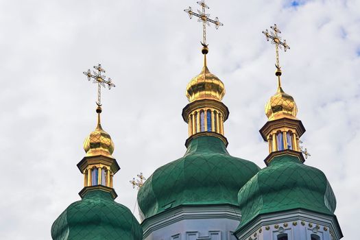 Golden domes with dark green roof of the Vydubychi Orthodox Monastery in Kiev