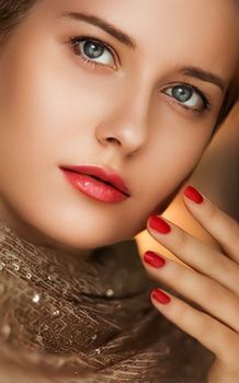 Beauty, makeup and glamour, face portrait of beautiful woman with manicure and red lipstick make-up wearing gold for luxury cosmetics, style and fashion