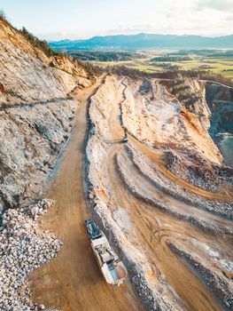 Vertical photo of gravel roads on the side of the open pit quarry