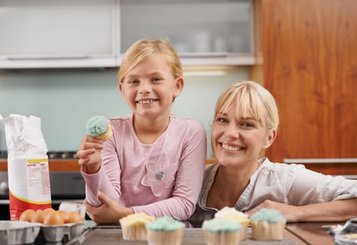 Baking together. an attractive young woman baking with her adorable daughter.