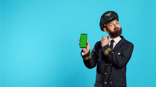 Positive aircrew captain showing phone with greenscreen