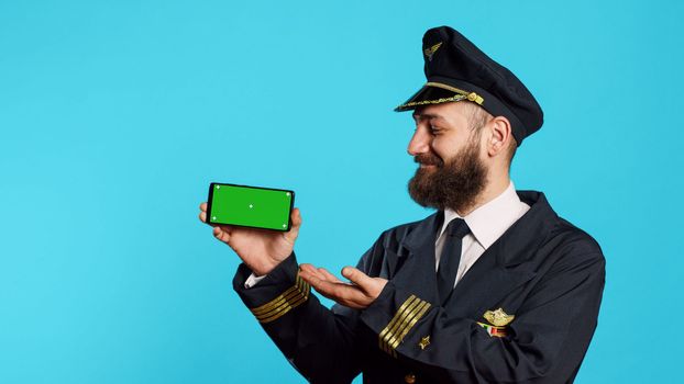 Caucasian man using greenscreen dressed as pilot