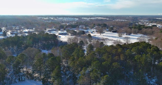 There is an aerial view of a small American town in South Carolina, US, just after a major snowfall, with an amazing snow scene in the sky.
