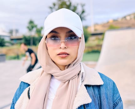 Beautiful young arab woman posing outdoors in a headscarf. Attractive female muslim wearing a hijab posing outside. Shes all about style and fashion. Mixed race woman looking confident and trendy