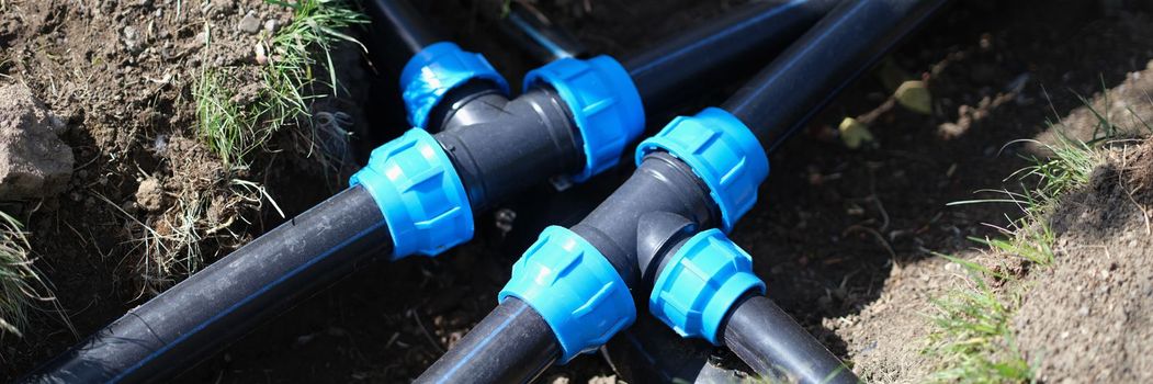 Connecting HDPE plastic water pipes in garden closeup