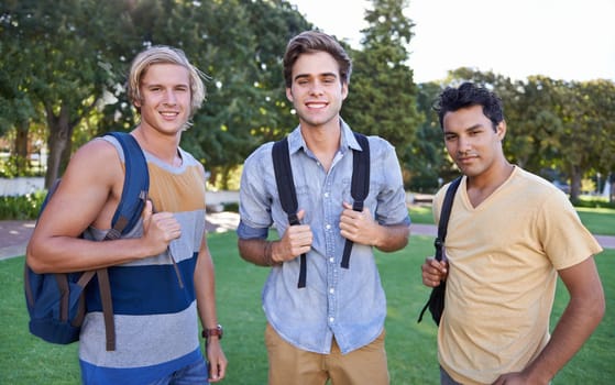 Ready to learn. Portrait of three students standing together in a park.