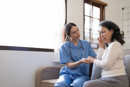 Female nurse visit old grandmother patient at home listen to complains concerns, attentive young woman doctor consulting mature senior grandma, elderly medical healthcare concept