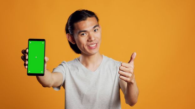 Happy person using greenscreen template on smartphone
