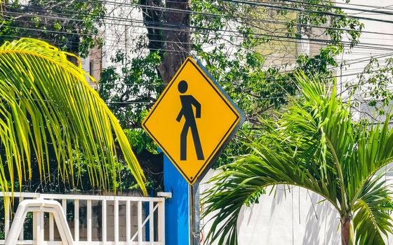 Yellow pedestrian sign street signin Playa del Carmen Mexico.