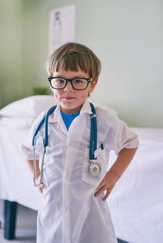 Mom said I could be anything. an adorable little boy dressed as a doctor.