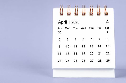 The April 2023 Monthly desk calendar for 2023 year on purple background.
