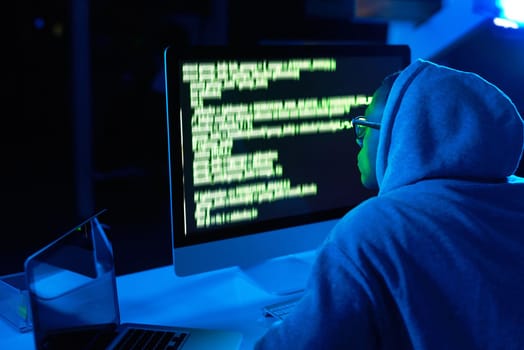 Theres a hack to everything in life. a young male hacker cracking a computer code in the dark.