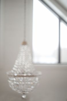 blurred crystal chandelier bokeh out of focus. Glamour background with copy space.