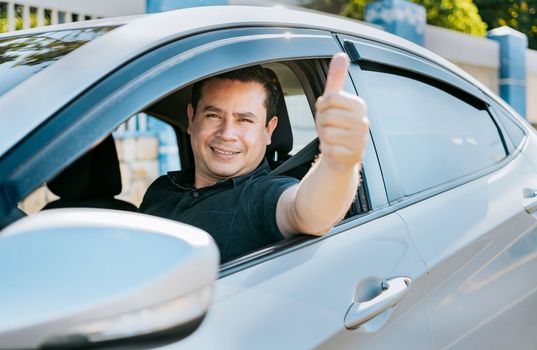 Man in his car giving thumbs up, Happy Driver giving a thumbs up. Satisfied driver man showing thumb up. Concept of satisfied car owner