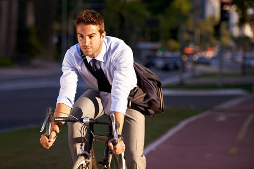 Really getting some exercise on the way to work. a businessman commuting to work with his bicycle.
