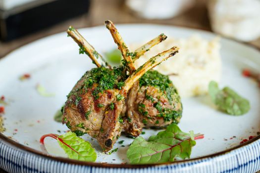 Closeup on gourmet lamb ribs cutler with herbs