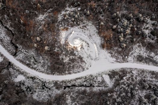 Aerial view of snow covered Bonny Glen Woods by Portnoo in County Donegal, Ireland.