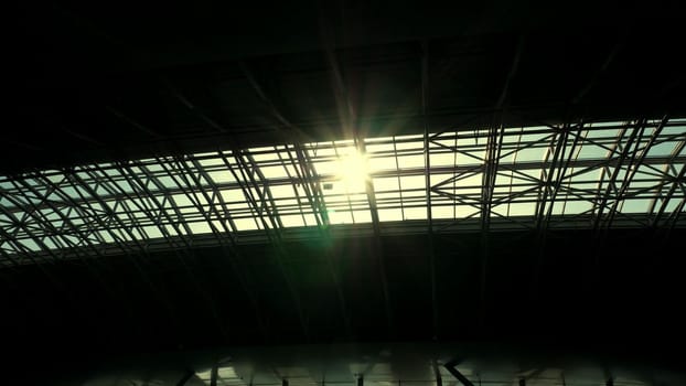 the sun shines through the roof of the airport pavilion
