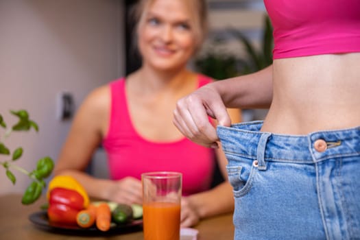 Two women in sporty pink tops at a health food table