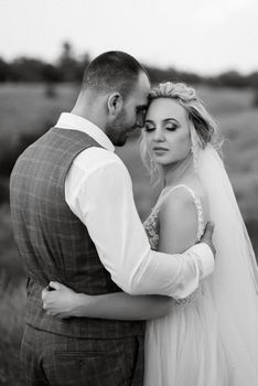 bride blonde girl and groom in a field