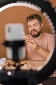Portrait bearded man making vlog review cosmetics product and channel recording video make up tutorial making at home - Online influencer guy and social media market live steaming concept