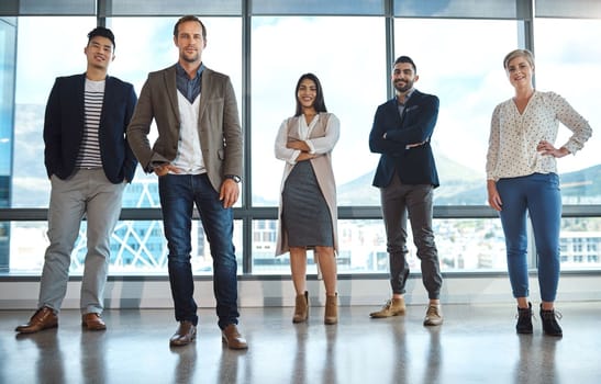 Were a force to reckoned with in the business world. Portrait of a diverse group of businesspeople standing in an office.
