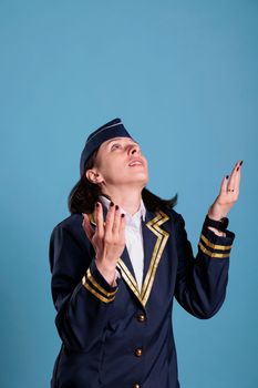 Prayer stewardess in aviation uniform begging