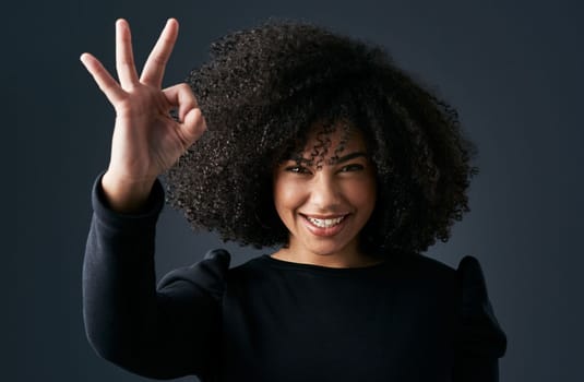 Change your perspective and youll change your life. a young businesswoman making hand gestures against a studio background.