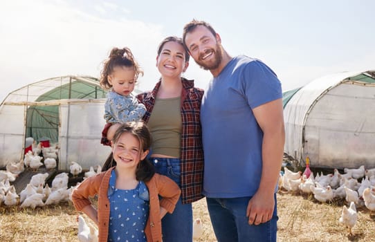 Raising children on a farm is fun. a couple and their two daughters on a poultry farm.