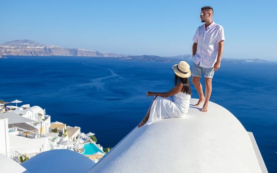 Couple on vacation in Santorini Greece, men and women at the streets of the Greek village of Oia
