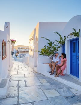 Couple on vacation in Santorini Greece, men and women at the streets of the Greek village of Oia