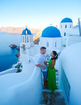 Couple on vacation in Santorini Greece, men and women visit the whitewashed Greek village of Oia
