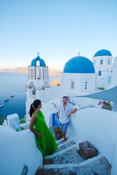 Couple on vacation in Santorini Greece, men and women at the Greek village of Oia