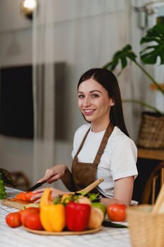 Young Healthy woman cooking healthy food in the kitchen at home. Healthy lifestyle, food, diet concept.