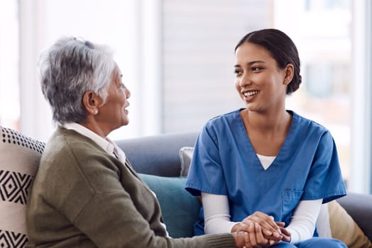 Your care could mean the world to someone. a young nurse chatting to a senior woman in a retirement home.