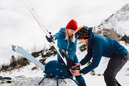 Couple getting ready for ski touring adventure in the Alps